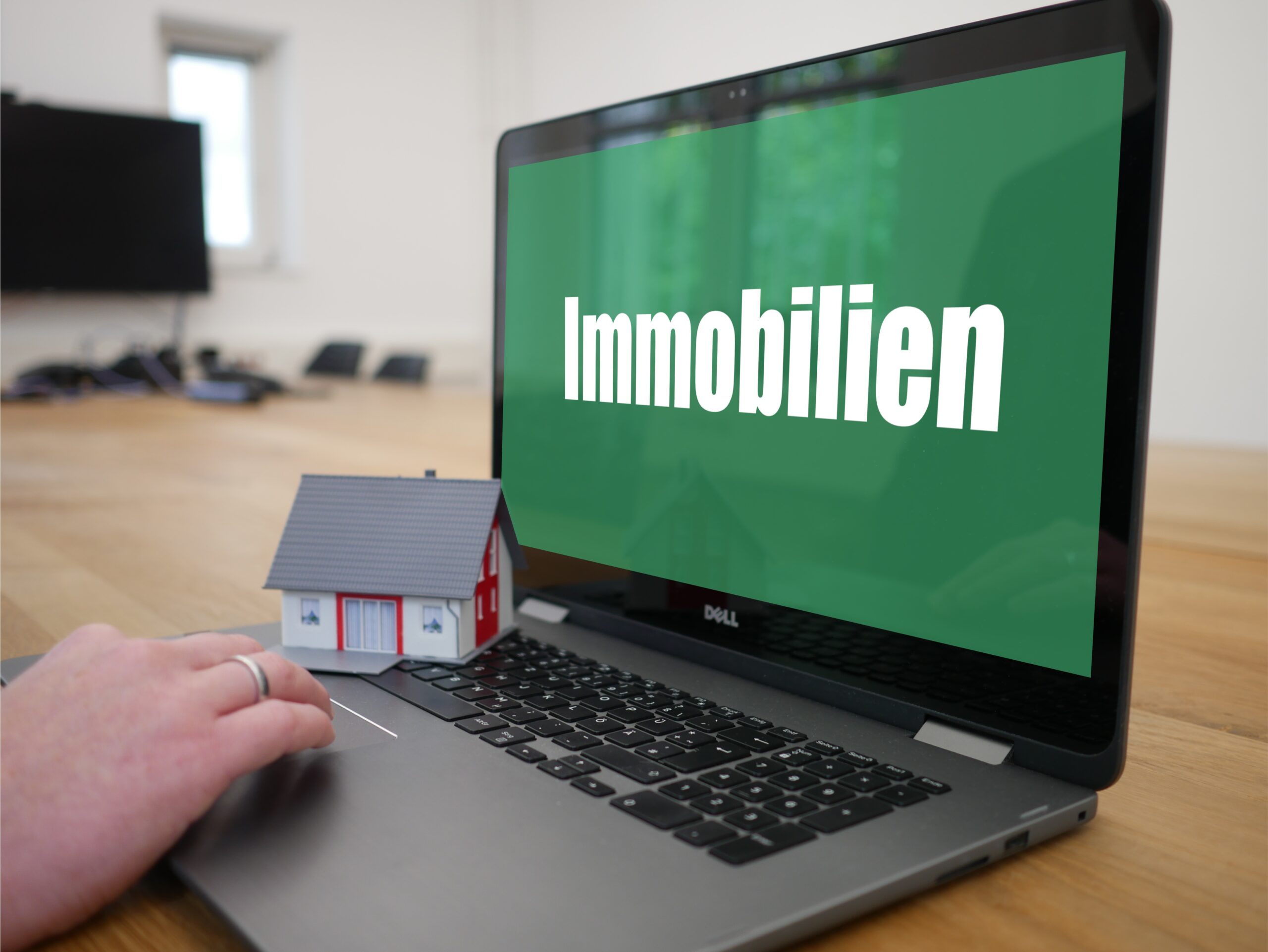 Steuerberatung Reindl, Hergenröder und Partner - Laptop mit einem grünen Bildschirm, auf dem Immobilien steht.