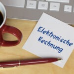 Steuerberatung Reindl, Hergenröder und Partner - Zettel mit dem Schriftzug Elektronische Rechnung neben einem Kugelschreiber und einer Tasse
